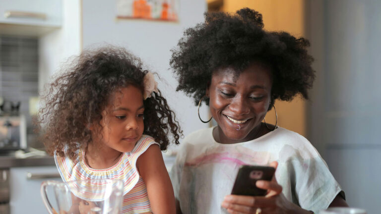 Mom and daughter looking at a phone