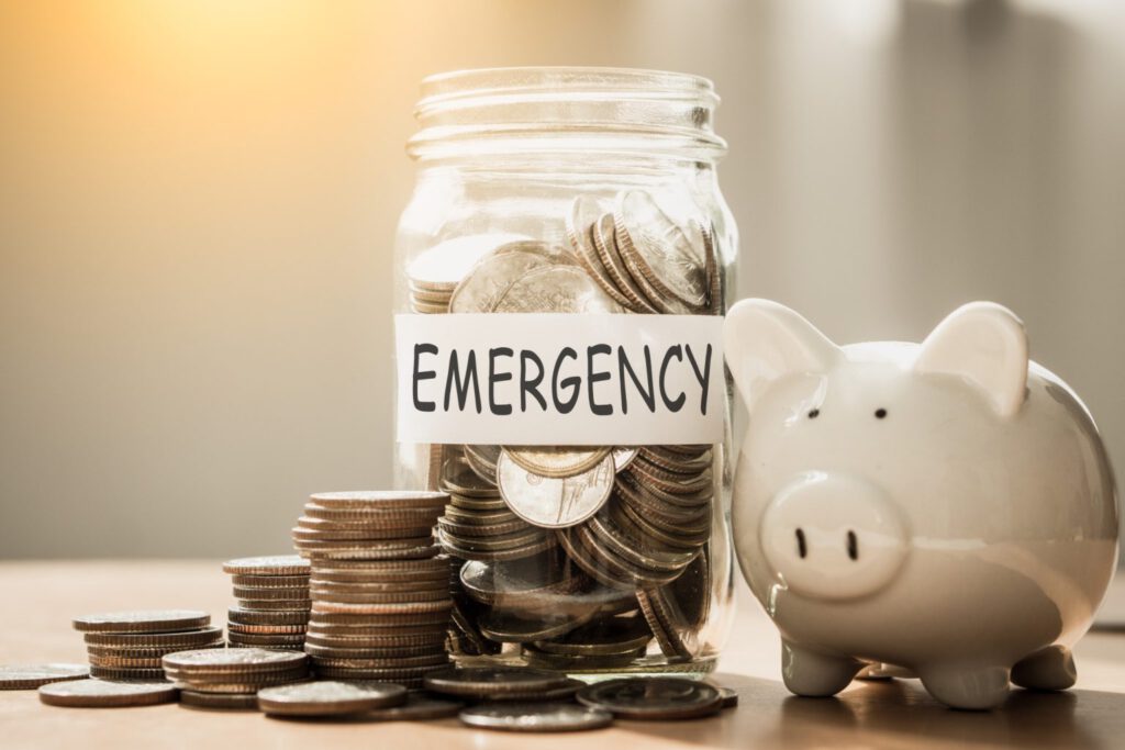 Coins and piggy bank marked emergency funds