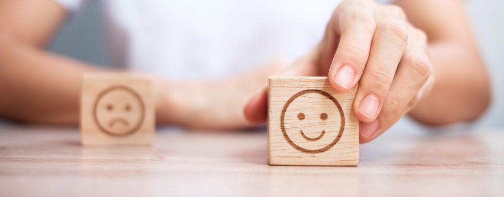 Wood blocks with sad and happy faces